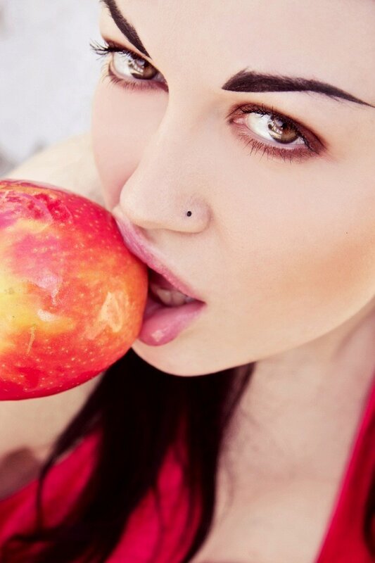 woman eating red apple