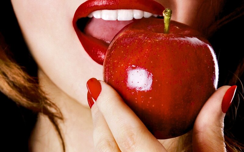 Woman Eating Red Apple — Dramatic