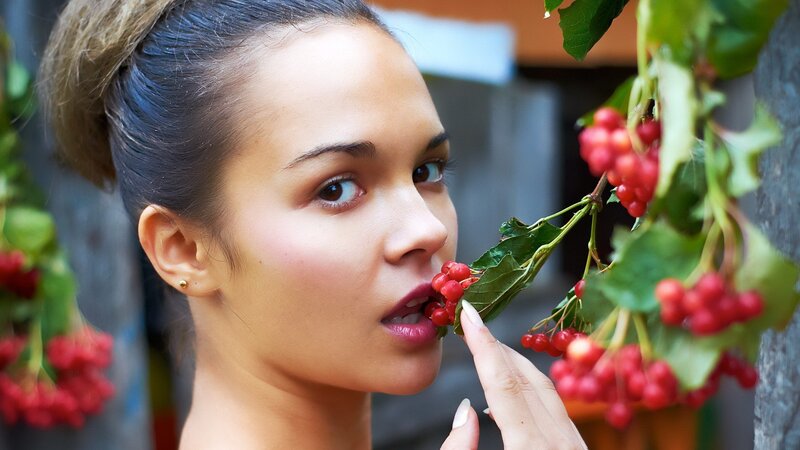 woman eating red berries