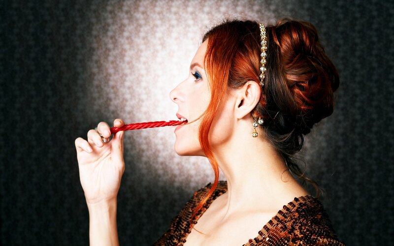 woman eating red candy
