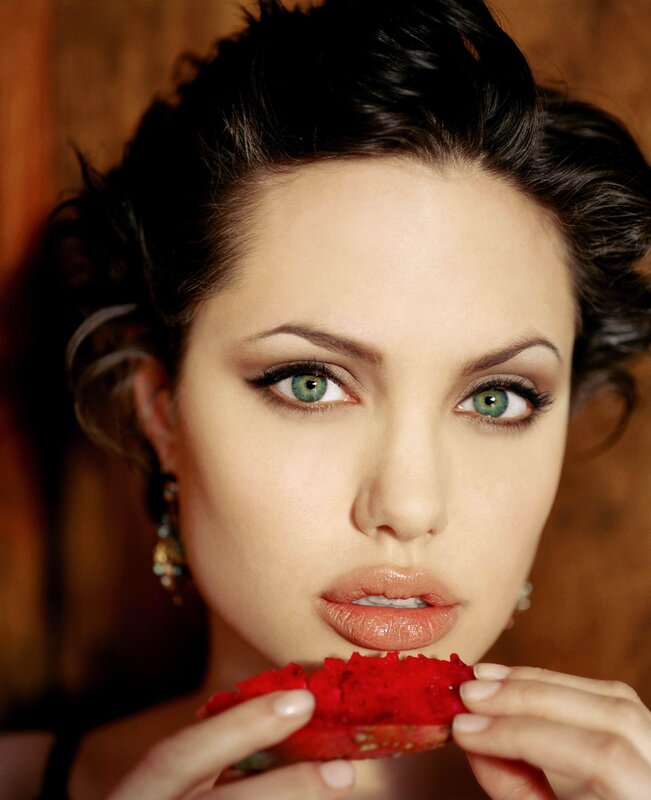 woman eating red fruit