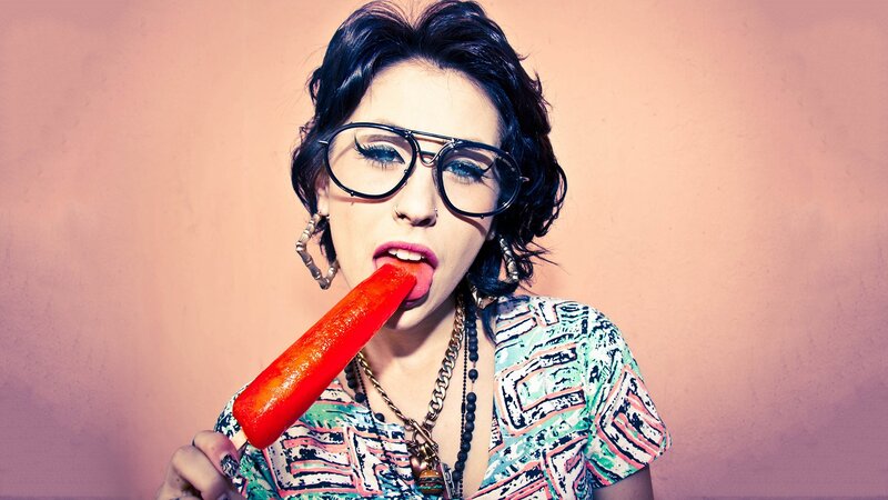 woman eating red popsicle