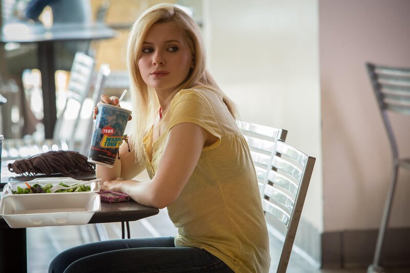 Woman eating salad at a cafe