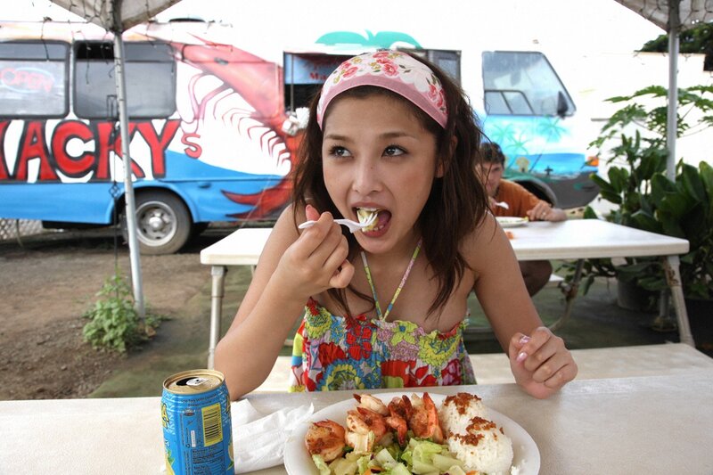 Woman eating shrimp at food truck