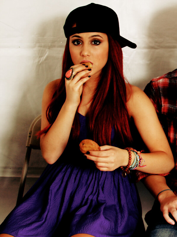 woman eating snack in purple dress