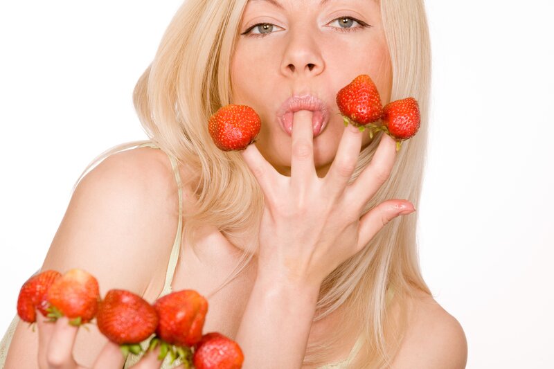 woman eating strawberries
