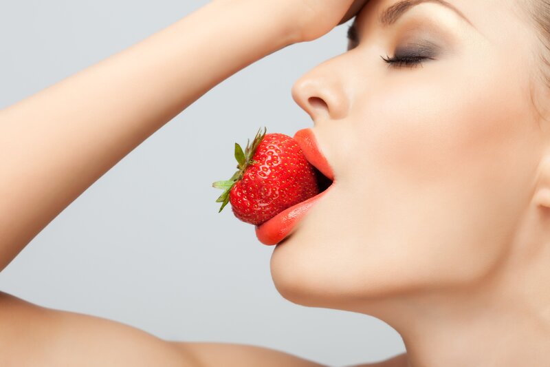 woman eating strawberry