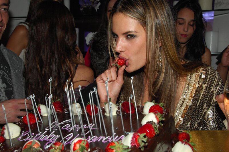 woman eating strawberry at birthday party