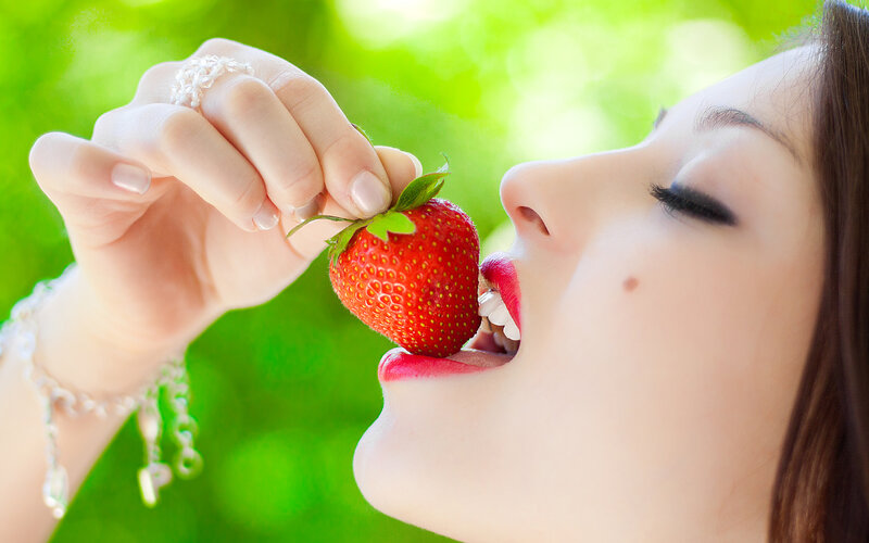 Woman Eating Strawberry — Red, Serene
