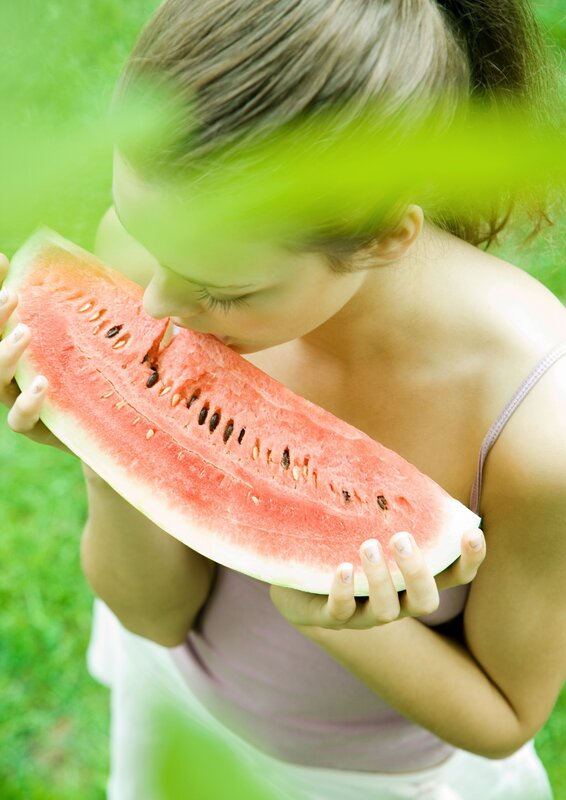 woman eating watermelon slice