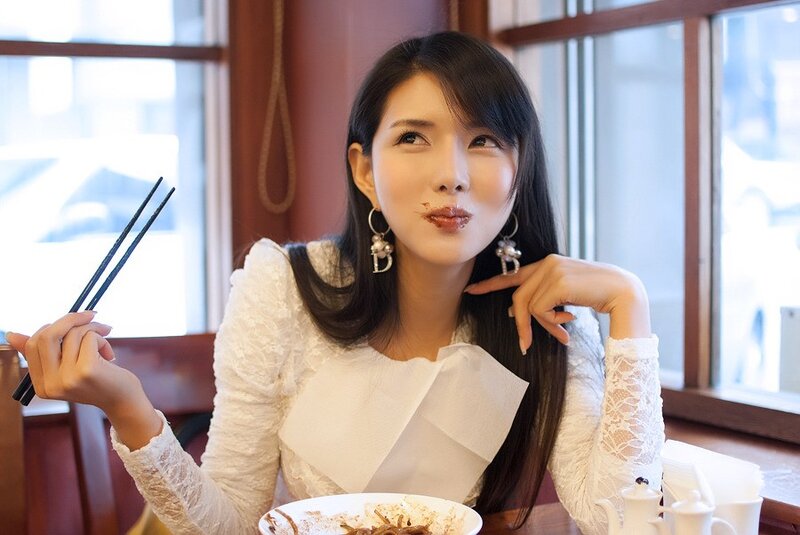 woman eating with chopsticks