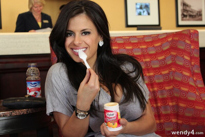 woman eating yogurt in restaurant