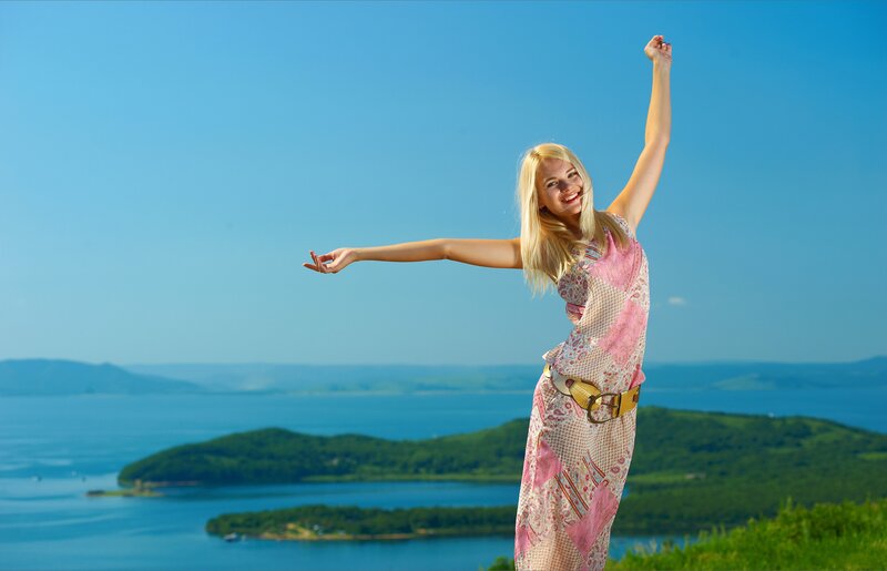 Woman enjoying a sunny day by the lake