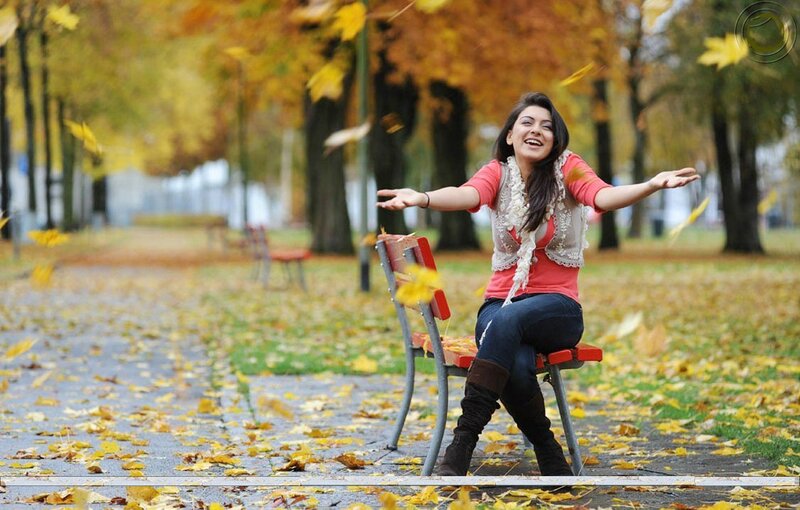 Woman enjoying autumn leaves
