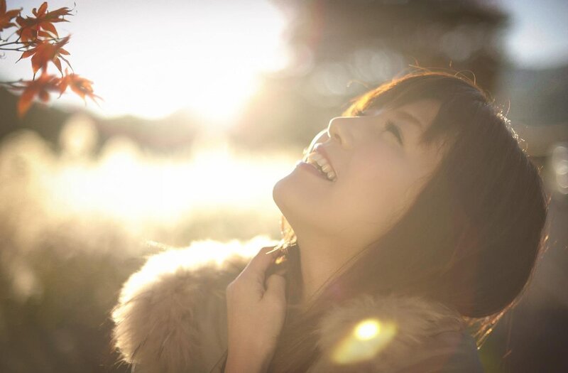 woman enjoying autumn sunlight