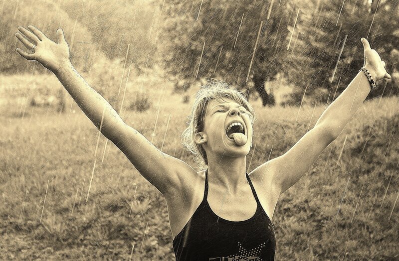 woman enjoying rain outdoors