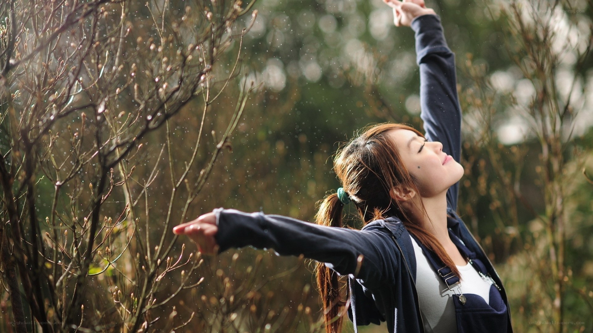 woman enjoying rain outdoors