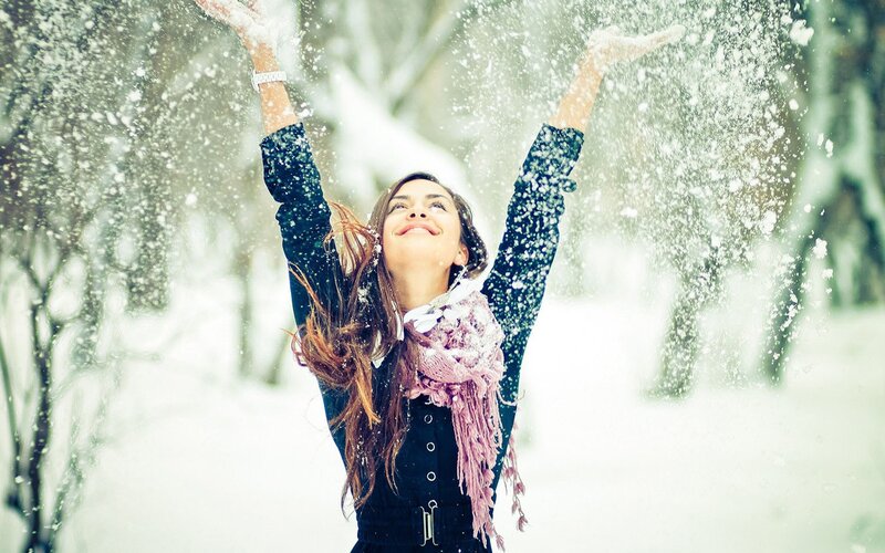woman enjoying snowfall outdoors