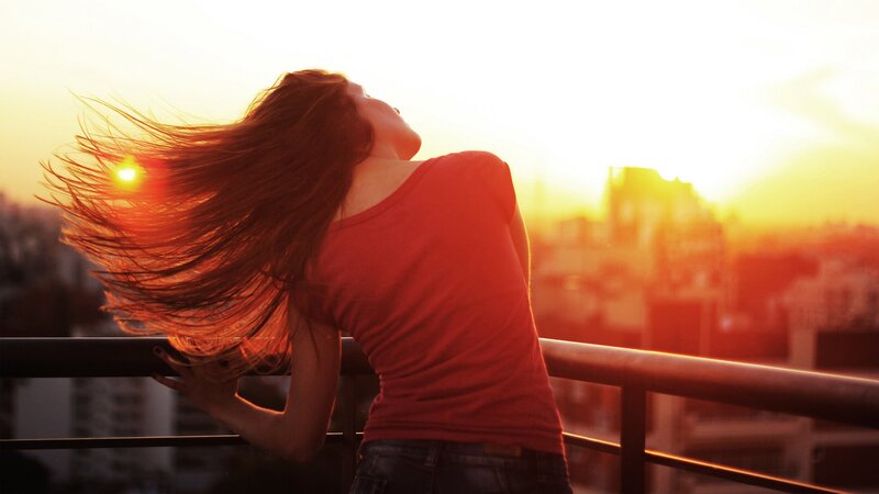 woman enjoying sunset on balcony