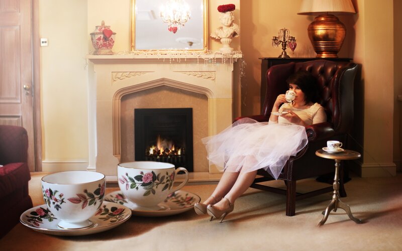 Woman enjoying tea by fireplace