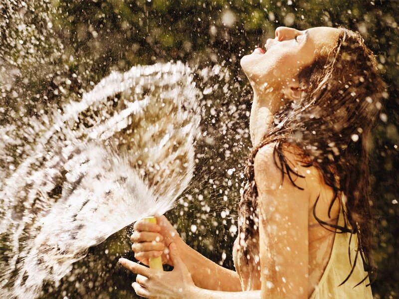 woman enjoying water spray