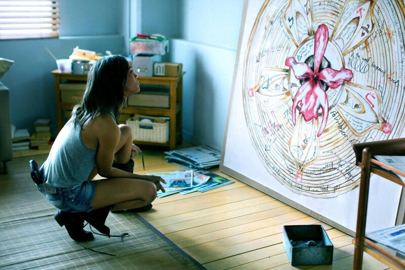 woman examining artwork