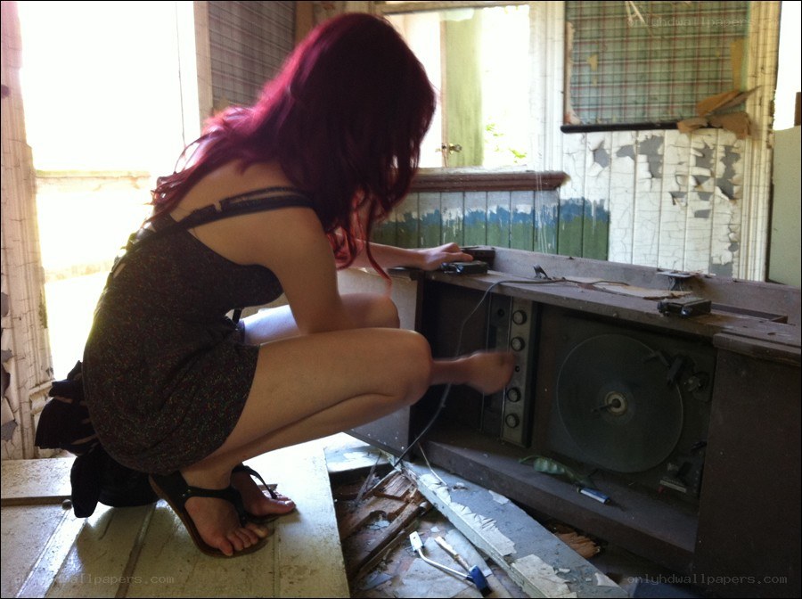 woman examining old record player