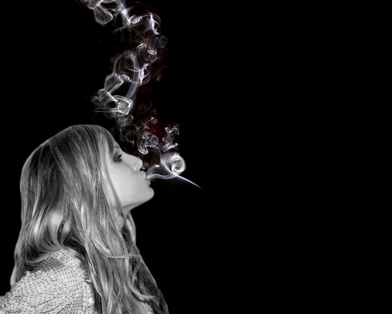 woman exhaling smoke
