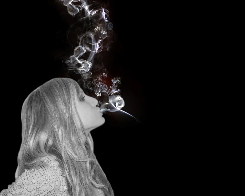 woman exhaling smoke