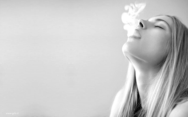 woman exhaling smoke