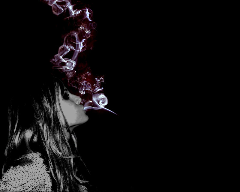 woman exhaling smoke