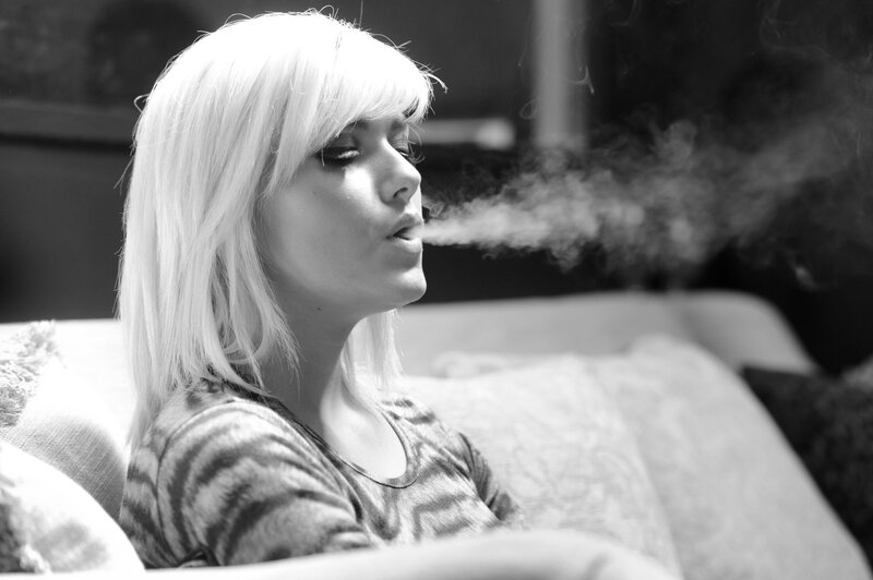 woman exhaling smoke