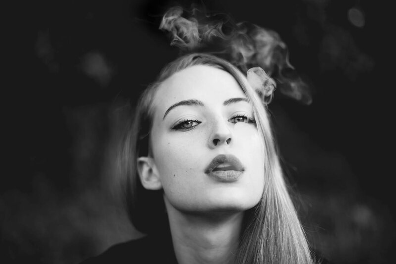 woman exhaling smoke