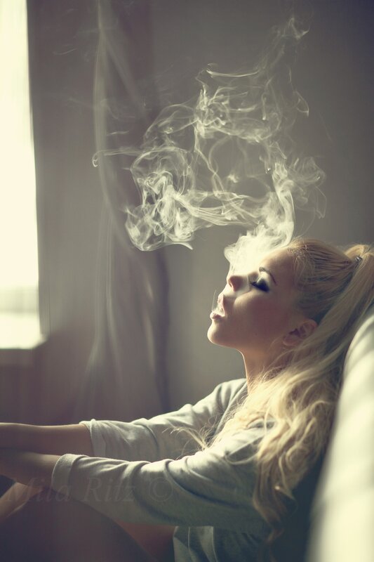 woman exhaling smoke