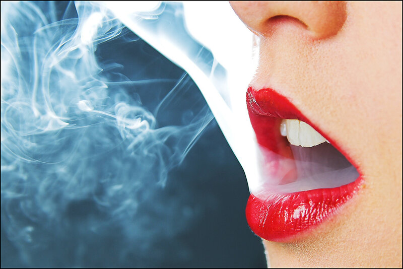 woman exhaling smoke