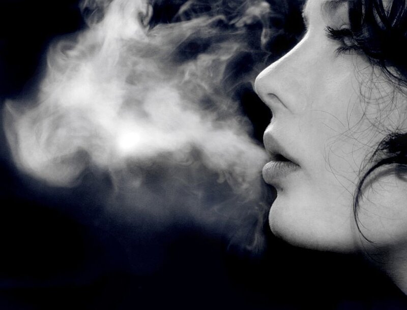 woman exhaling smoke
