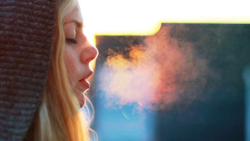 woman exhaling steam in cold