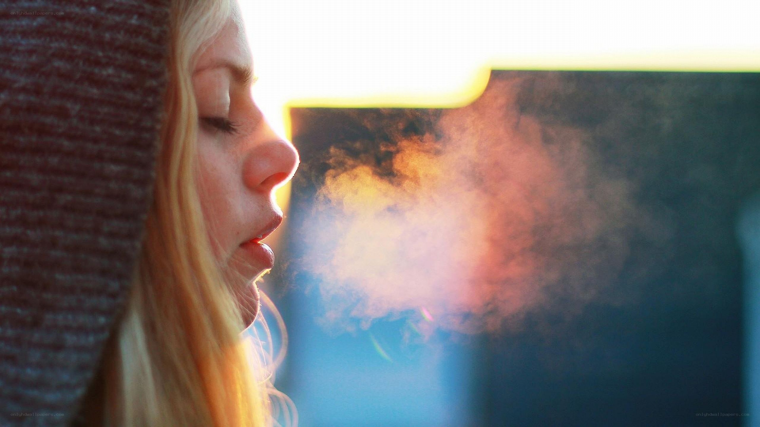 woman exhaling steam in cold