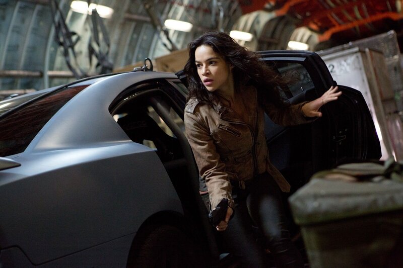 woman exiting car with gun
