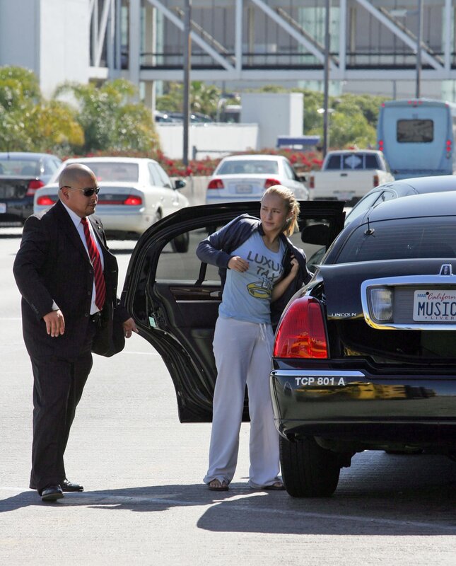 Woman exiting luxury car