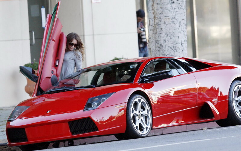 Woman Exiting Red Car