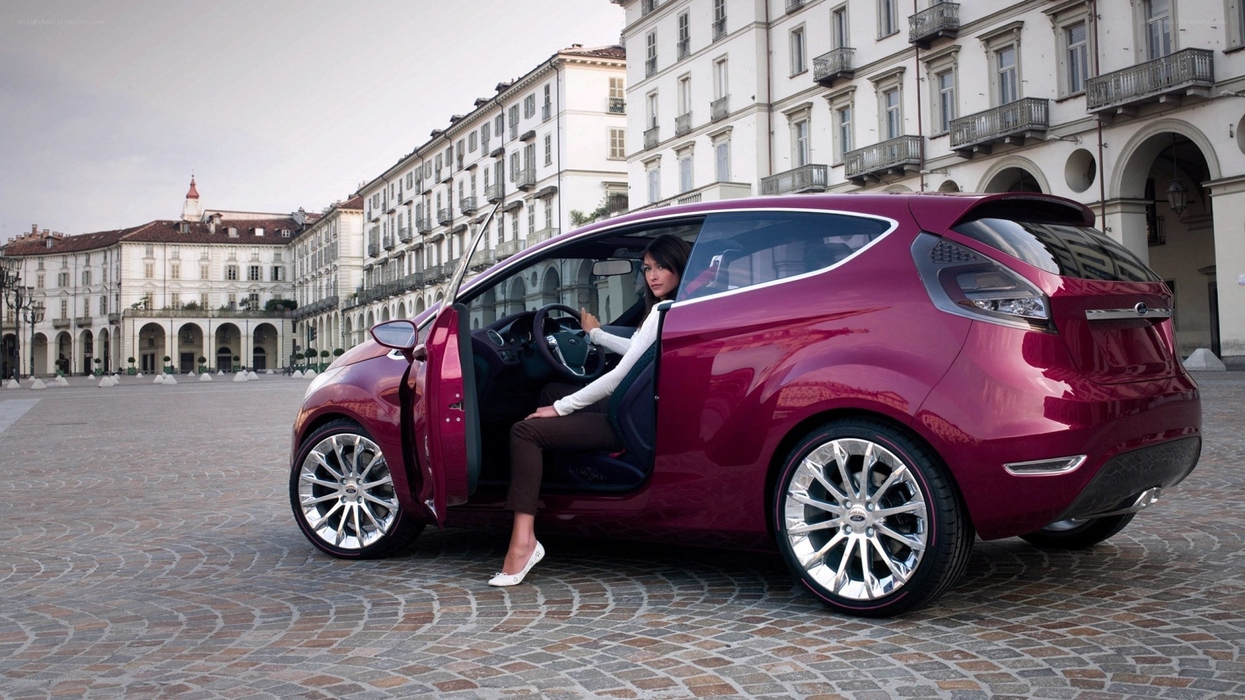 Woman exiting red concept car