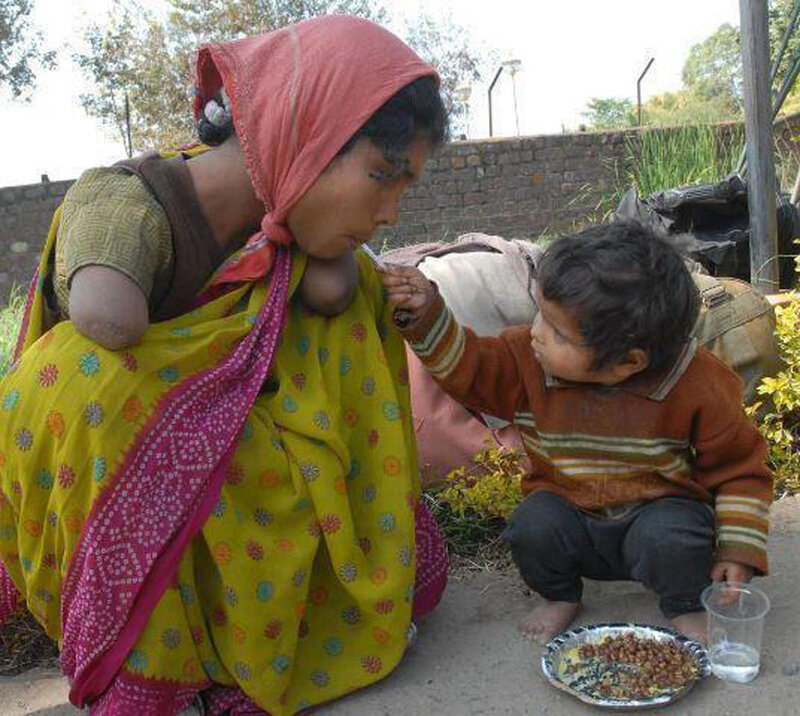 Woman Feeding Child