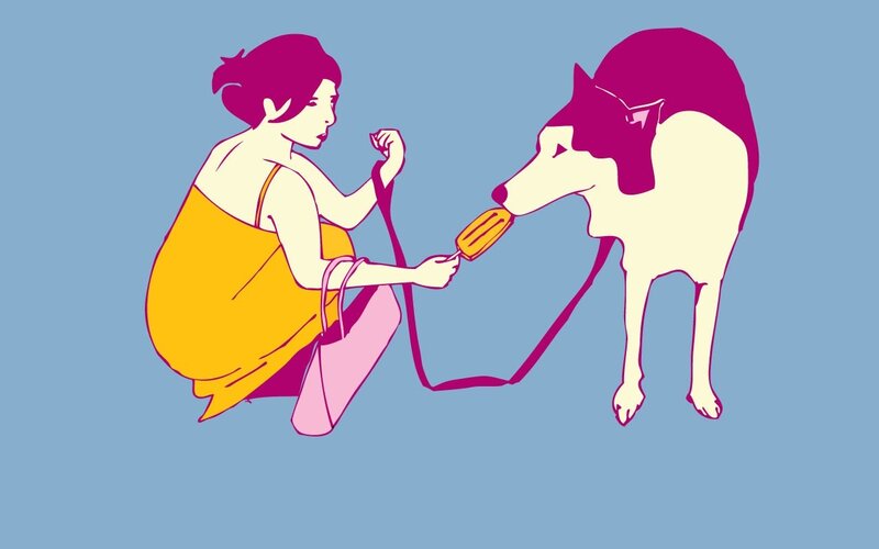 woman feeding dog ice cream