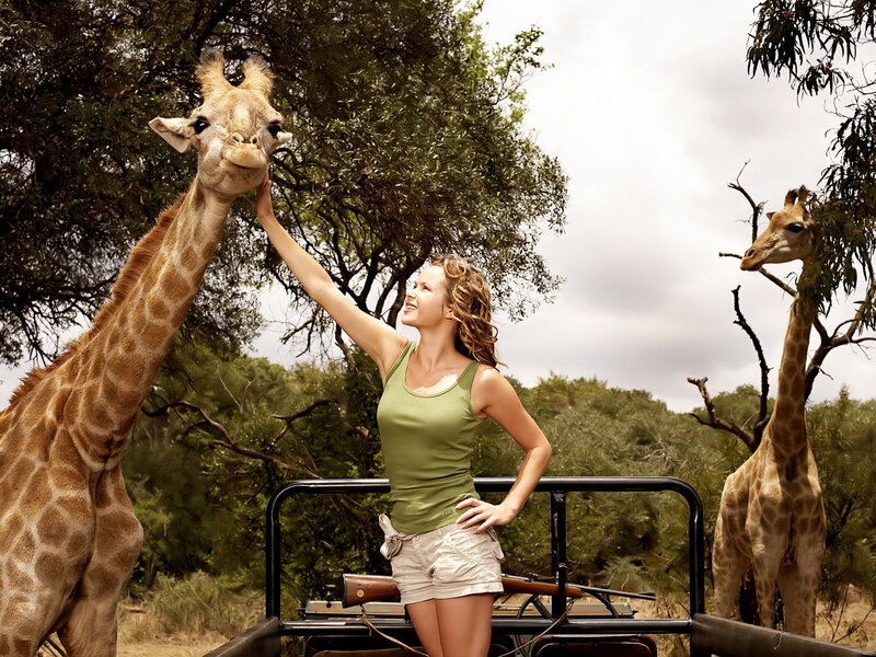 Woman Feeding Giraffe