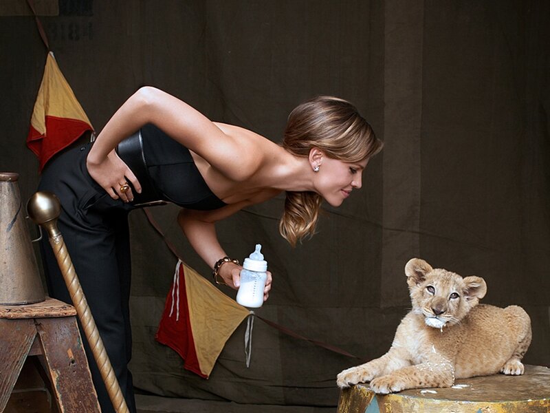 Woman Feeding Lion Cub
