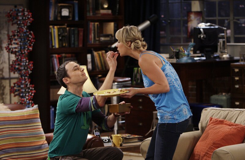woman feeding man in living room