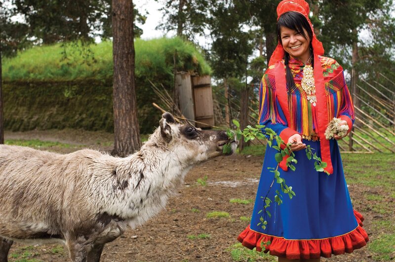 Woman Feeding Reindeer