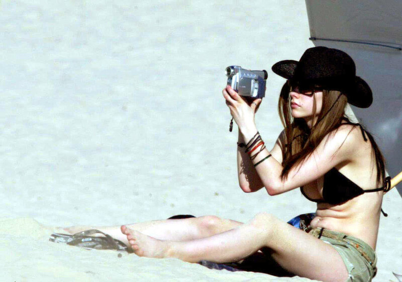 Woman filming on beach