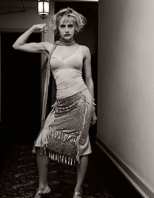 woman flexing in sequined skirt
